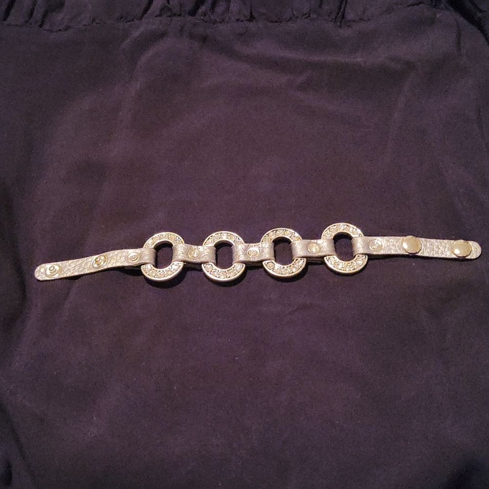 Bracelet, faux silver leather w/faux silver metal and sparkle accents. Adjustabl